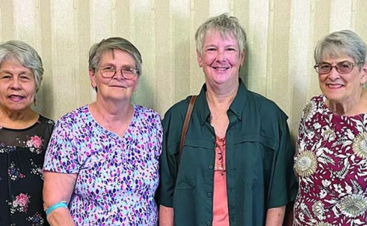 Celebrat ion House Food Pantry in Flat onia representatives acknowledging the donation of hamburger from NVCW are Julia Webster (left), secretary; Evelyn Miller (second from left), director; and Enid Waska (right), assistant director. Representing NVCW is Jackie Harker (second from right).
