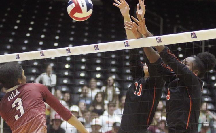 Meredith Magliolo (No. 11) and Jessalyn Gipson team up for a block in the third set. Sticker Photo By Darrell Vyvjala