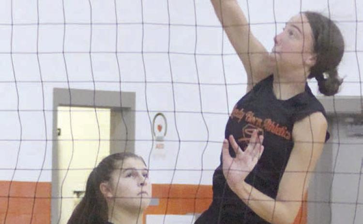 Meredith Magliolo hammers down a set from Landry Zapalac during pre-season workouts last week. The two are among four returning all-state selections for the Lady Horns this season. Sticker Photo By Darrell Vyvjala