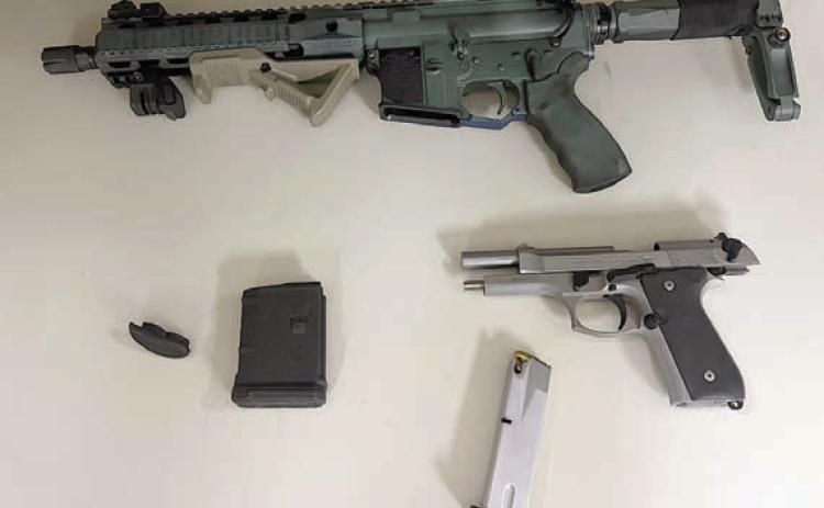 A 9mm Beretta handgun and an AM-15 rifle were retrieved during the incident in which the suspect pointed the handgun at a deputy.