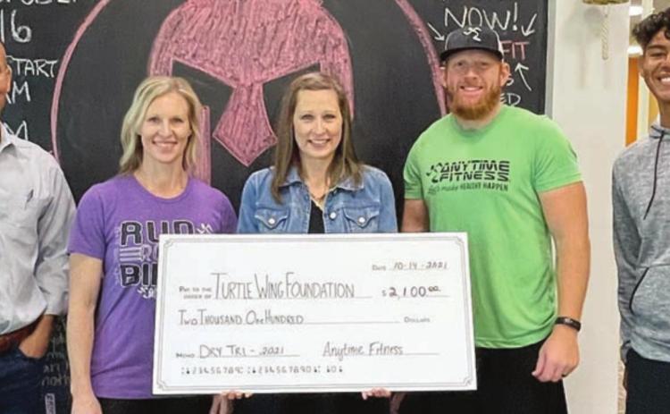 $2,100 DONATED – On hand for the presentation of a donation of $2,100 from the Anytime Fitness Dry-Tri to Turtle Wing Foundation were (from left) Chip and Kim Bubela, Anytime Fitness owners; DeeAnn Hooper, Turtle Wing founder and president; Mitch Bailey, Anytime Fitness Schulenburg club manager; and Jean Gonzales, personal trainer