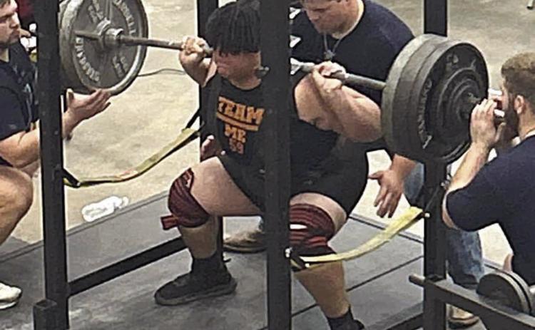 Calvin Thompson sets a personal best in the squat by pushing up 600 pounds at the state meet.