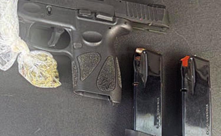 Shown above are the handgun and marijuana found by SPD officers in a vehicle after a traffic stop.