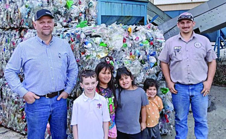 Science Club members with recycling center staff – (from left) recycling manager Paul Zapalac; students Cason Hale, Rebecca Camacho, Sophie Camacho and Victoria Camacho; and recycling attendant Gary Eudy.