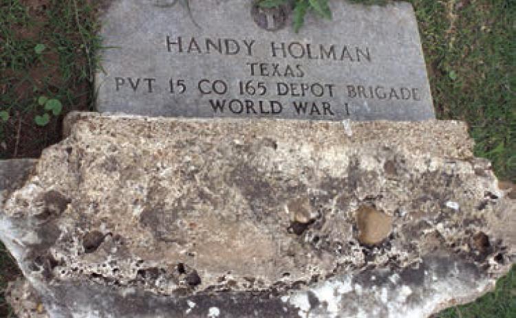 Handy Holman Jr. Headstone, overturned but still visible in the Holman Cemetery. The inscription reads “Handy Holman, Texas, Pvt., 15 Co. 165 Depot Brigade, World War I.” Photo Courtesy of Dr. Michelle and Anthony Hill