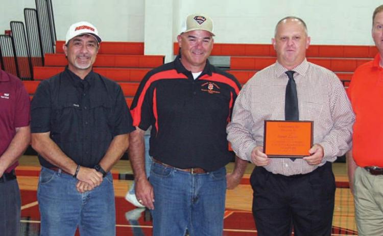 School officials present plaque to coach Zapalac