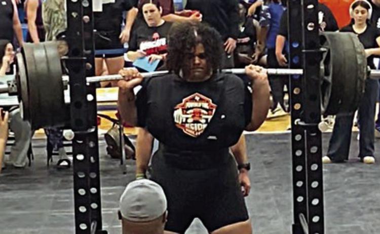 Calvin Thompson steadies himself before a squat attempt at the regional powerlifting meet on Friday in Navasota.