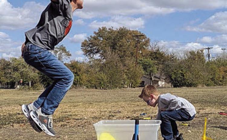 Students experiment with the principal of air pressure using stomp rockets.
