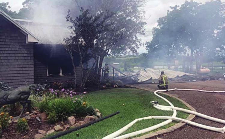 Multiple lines remain handy and smoke drifts from the home in the Freyburg area after firefighters extinguished the blaze on June 1. The carport (at right) burned to the ground and one adjoining section was a total loss but about half of the structure was saved. Photo Courtesy of Schulenburg VFD