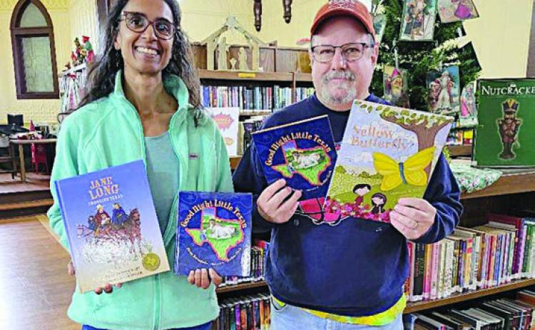 Round Top Family Library received books from Night Heron Media just before Christmas. Keelia Ritch (left), library manager, represents RTFL in accepting the donation from Mike Vance (right), Night Heron Media creative/video director.