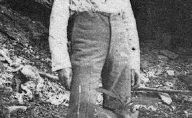 Frank Hausmann standing below the bluff. – Courtesy of Fayette Heritage Museum &amp;Archives