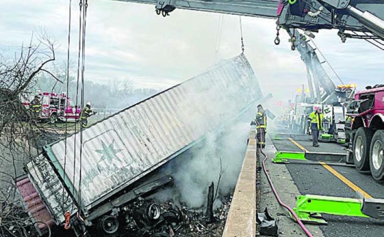 Cranes hoist the trailer from the creekbed as part of the cleanup that continued throughout Monday morning after the accident. Photo Courtesy of SVFD