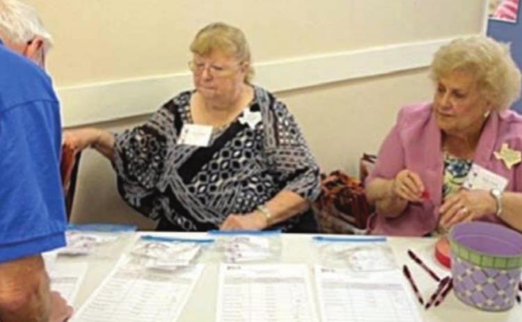 SERVING AS HOSTS AT THE REGISTRATION TABLE for the 2022 District 11 Extension Education Spring Conference held in La Grange were Janice Alexander and Carolyn Fritsche, Fayette County Extension Education Association members.